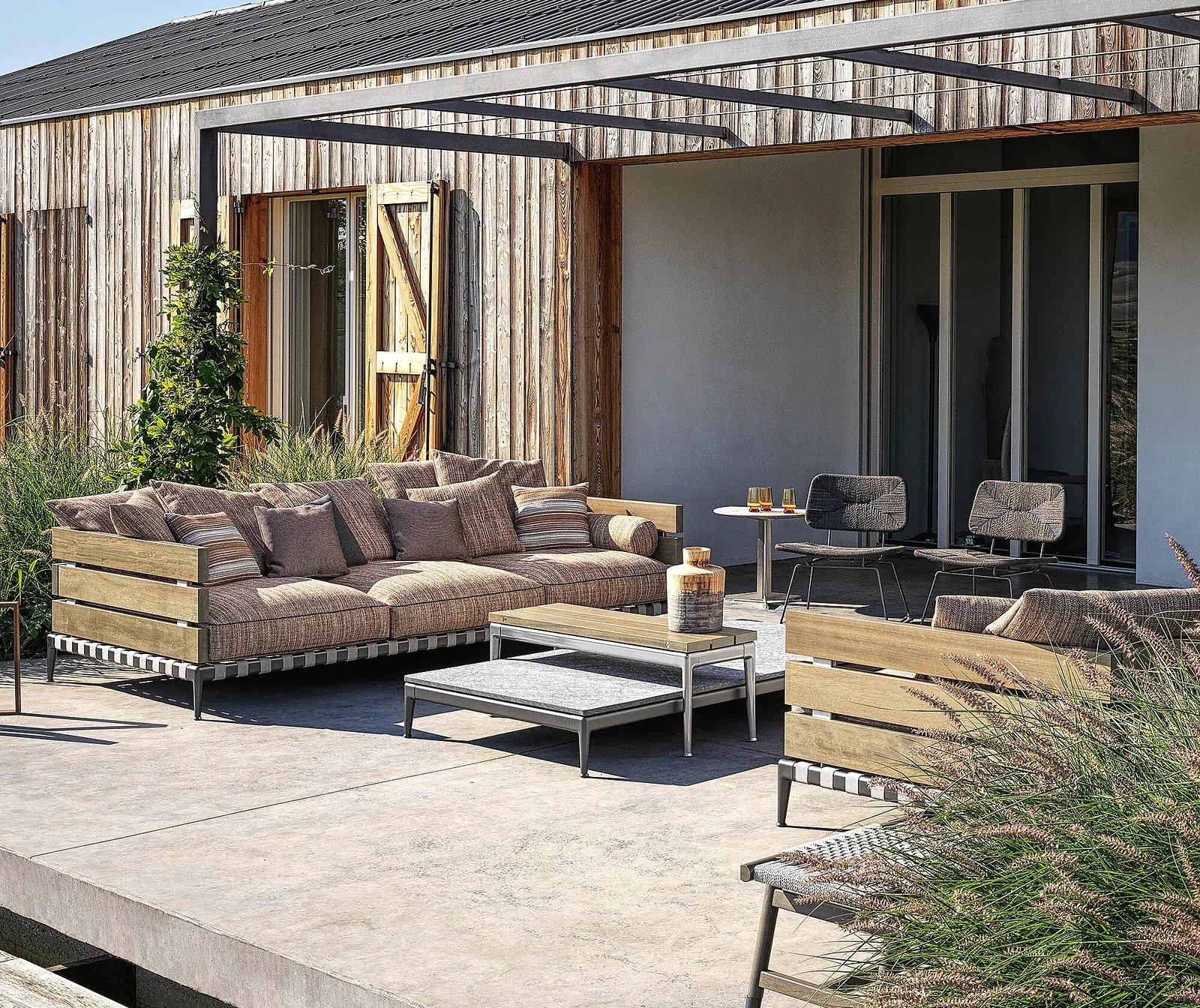 Flexform Ansel outdoor sofa in a garden setting, frame 1
