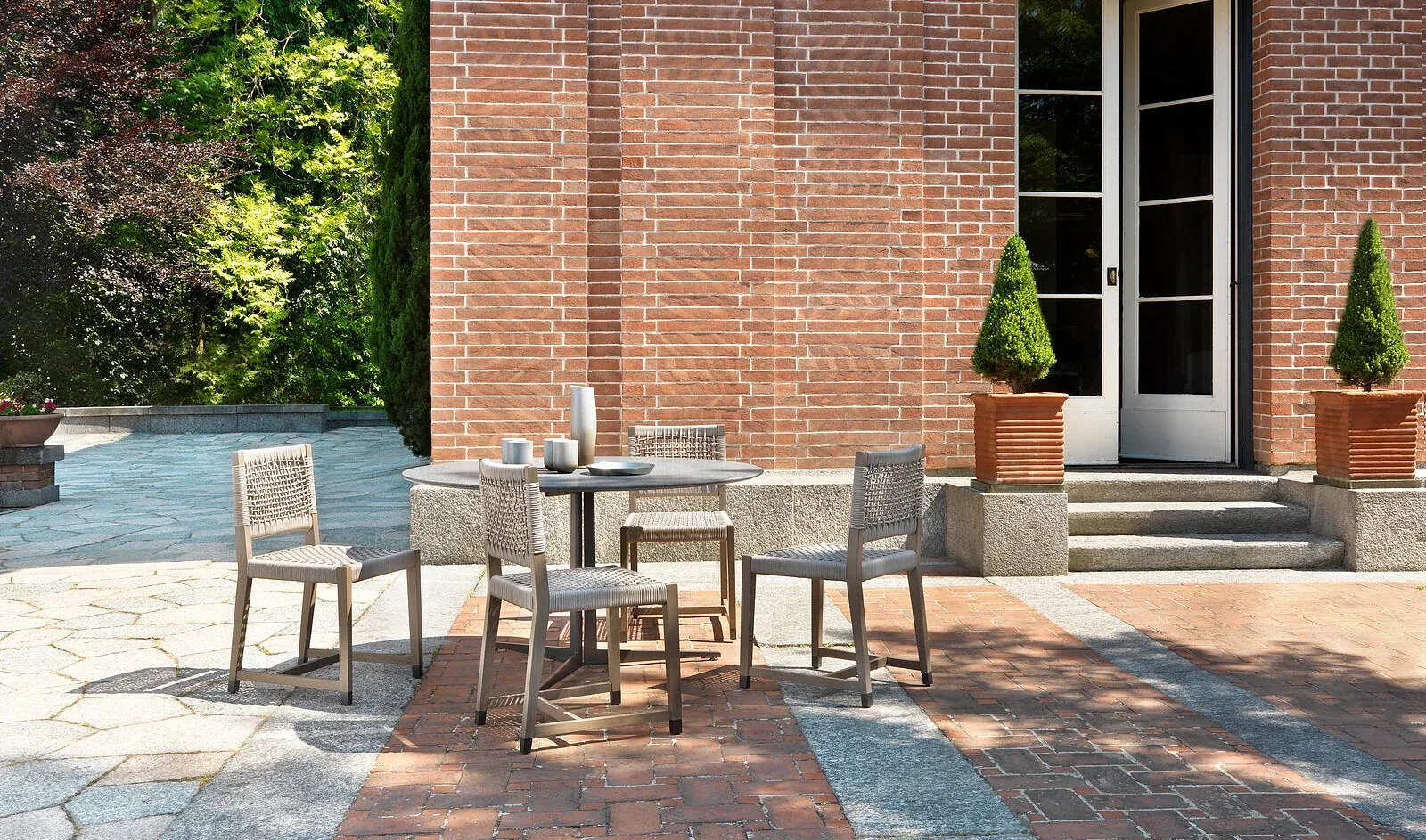 Flexform Dafne outdoor chair in a garden setting, frame 1