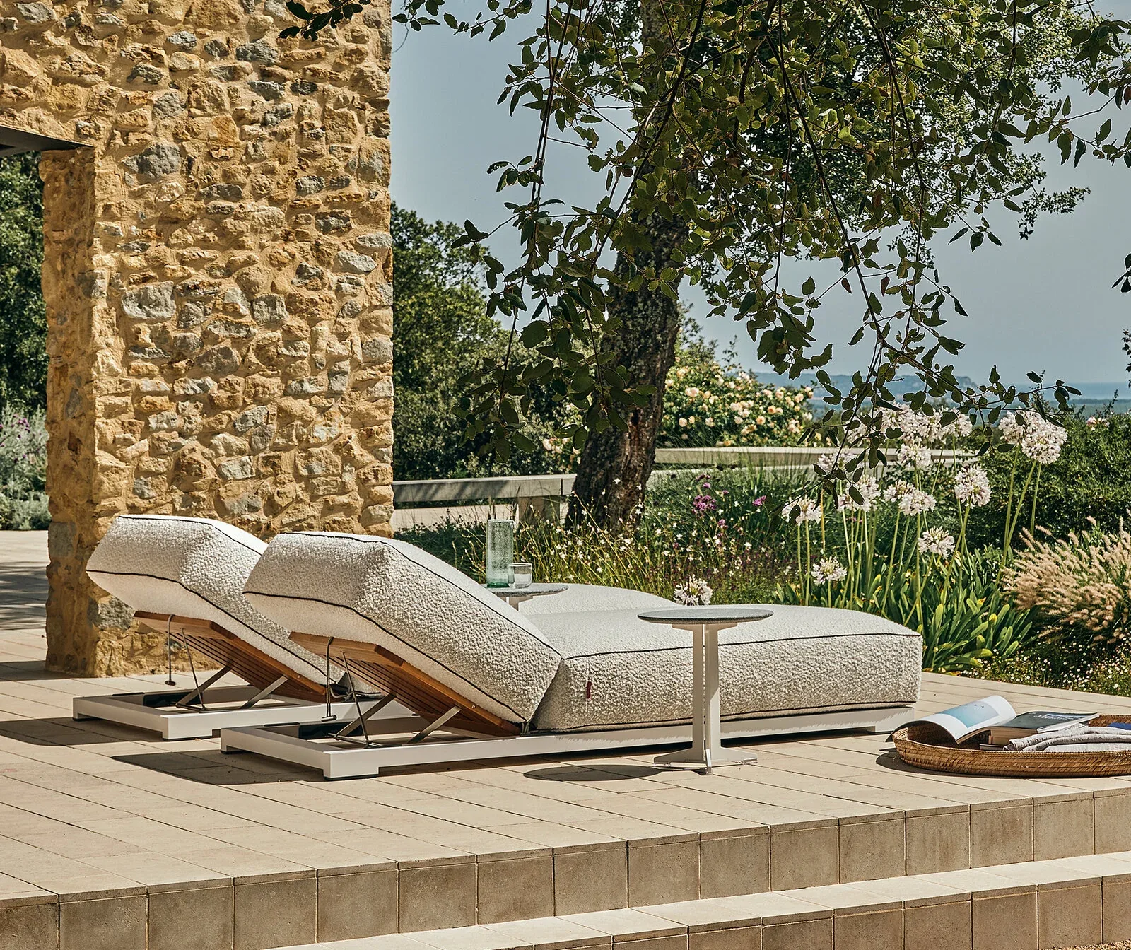 Flexform Fly outdoor coffee table in a garden setting, frame 3