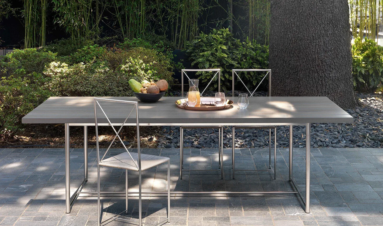 Flexform Levante outdoor table in a garden setting, frame 1