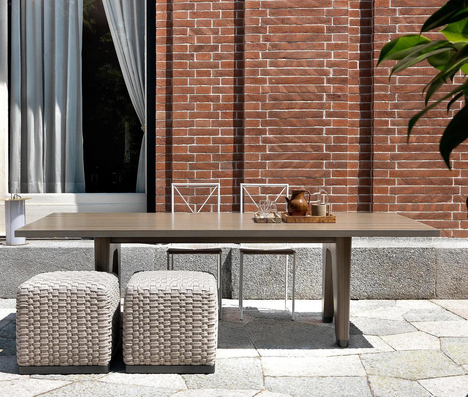 Flexform Monreale outdoor table in a garden setting, frame 1