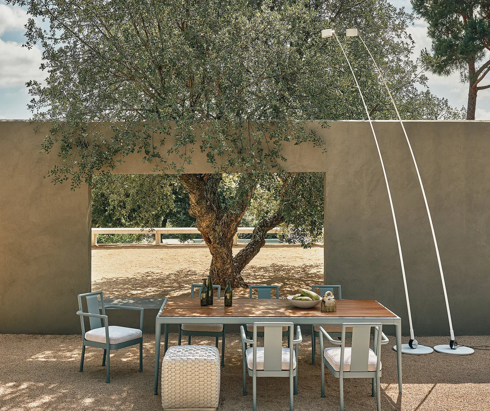 Flexform Phuket outdoor ottoman in a garden setting, frame 1
