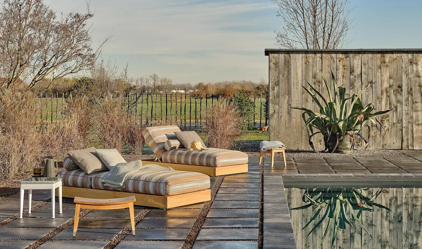 Flexform Pico outdoor coffee table in a garden setting, frame 2