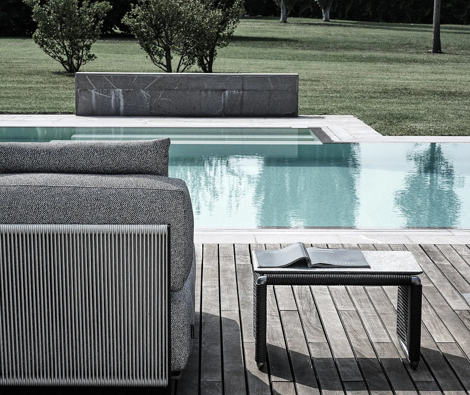 Flexform Tindari outdoor coffee table in a garden setting, frame 1
